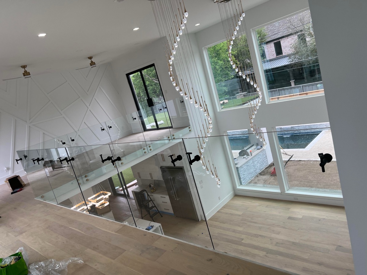 Frameless glass railing with standoff hardware — luxury home