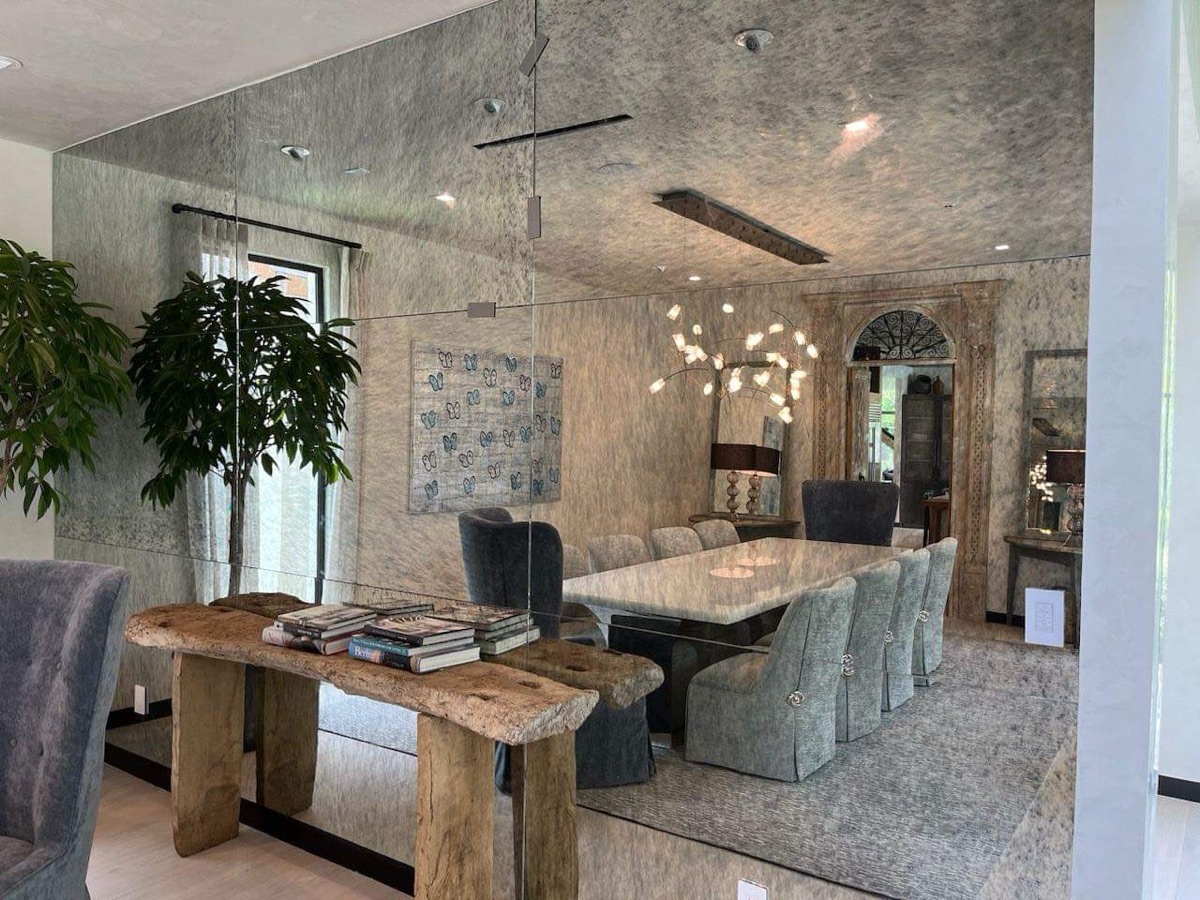 Full antiqued mirror accent wall — luxury dining room
